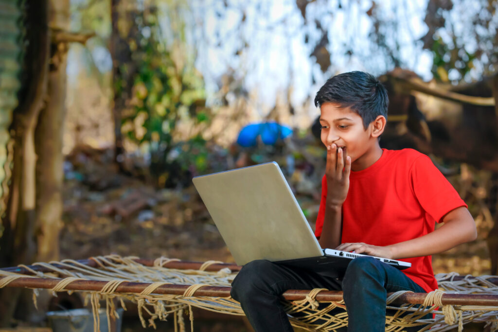 cute-little-indian-asian-boy-studying-playing-game-with-laptop-computer Boy learning on a laptop - edtech