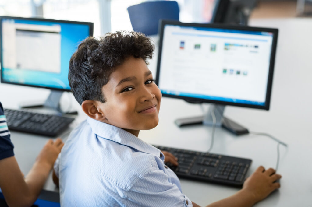 School boy using a computer Edtech & Smart Learning